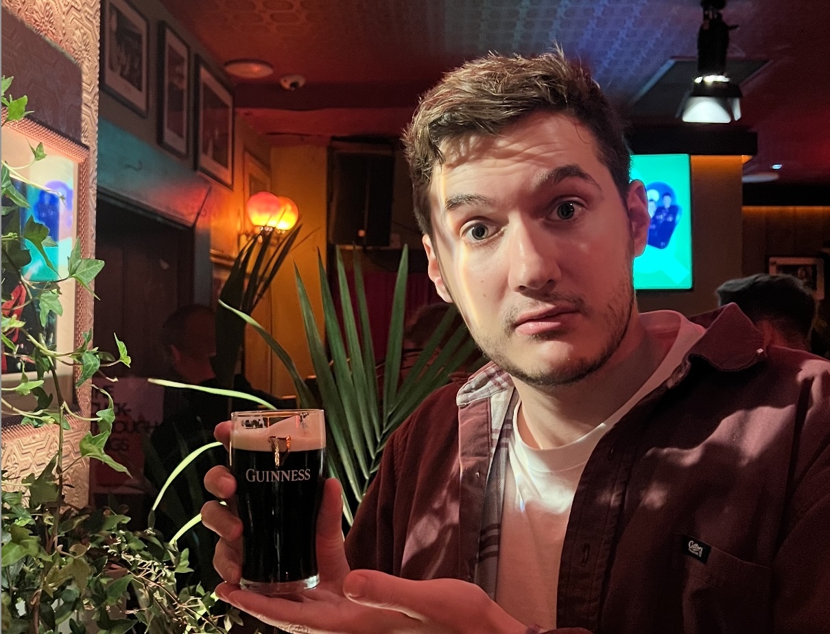 Dave, Head of Paid Media at Bind, holding up a small Guinness in Dublin